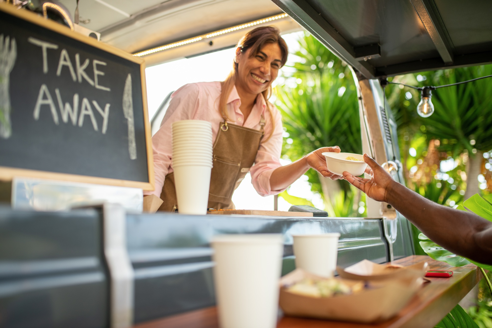 Cheerful woman taking selfie in cafe